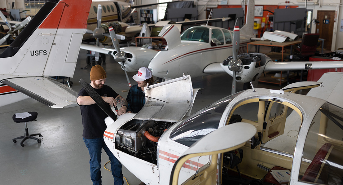 Students working in the Aircraft Maintenance Technology's hanger
