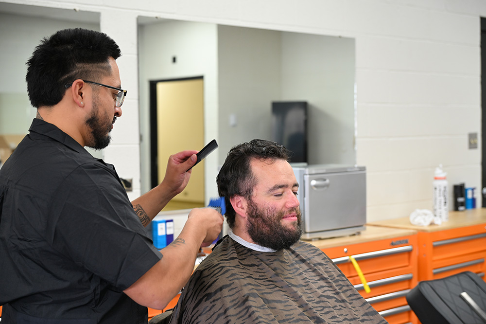 Barbering instructor working on a clients hair