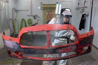 Auto Collision Repair and Refinishing student painting a grill