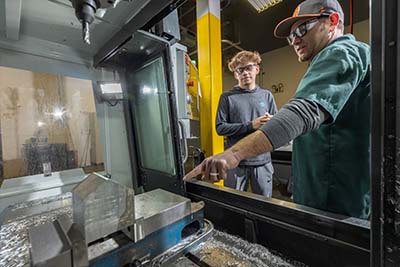 Computerized Machining student working with an instructor