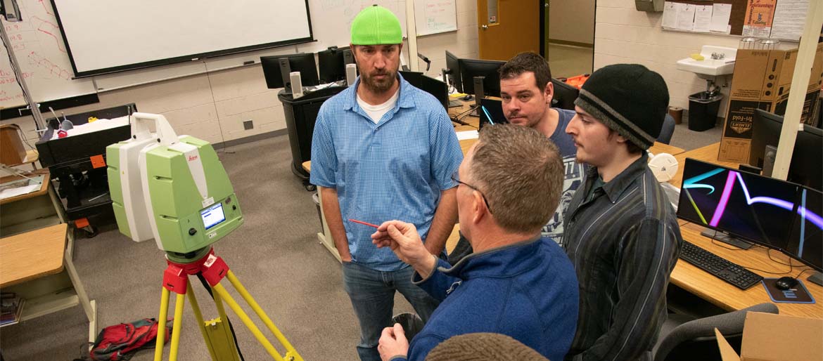 Students working with instructor during a lab