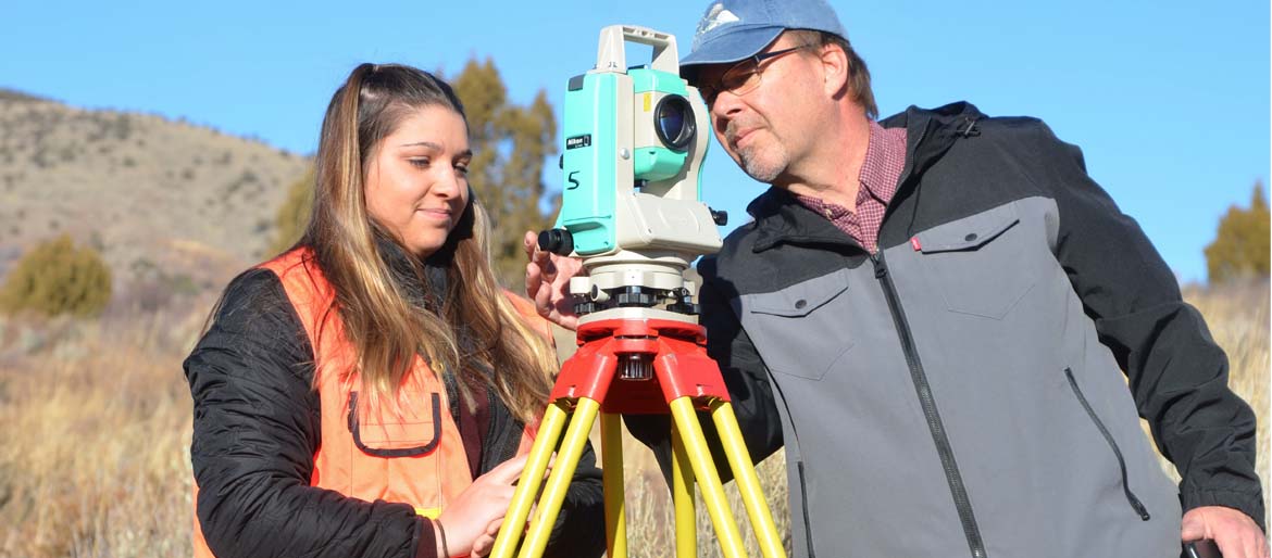 Robert Liimakka  Clinical Assistant Professor / Coordinator Surveying and Geomatics Engineering Technology working with a student