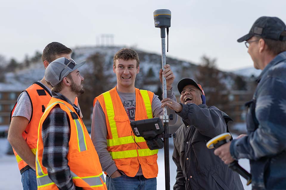 Students working with instructors to use survey tools