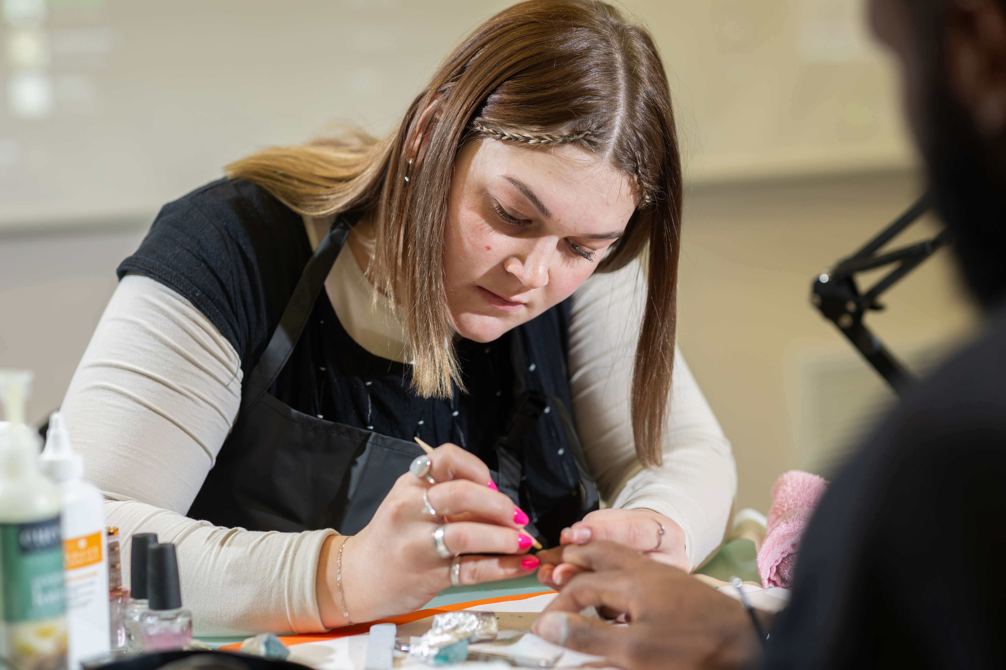 Nail Technician painting a clients nails