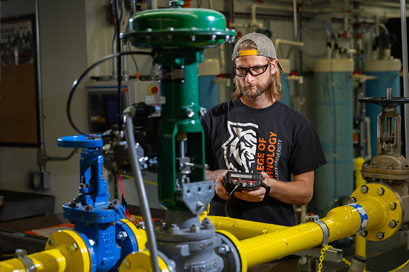 Instrumentation Engineering Technology student working with a flow loop