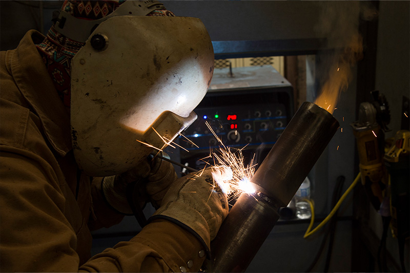 Student welding pipe