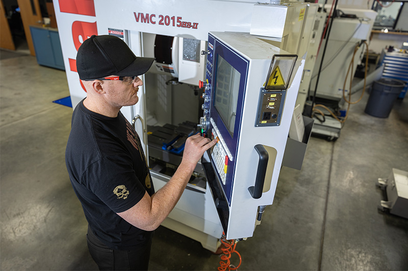 Computerized Machining student working on a CNC control pannel
