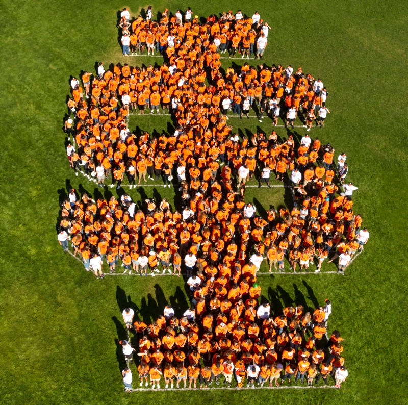 New students standing in an IS logo formation