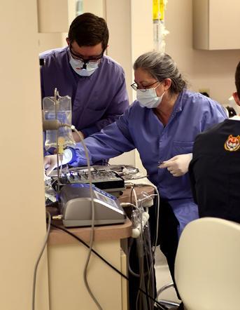 Students learning how to use dental tools