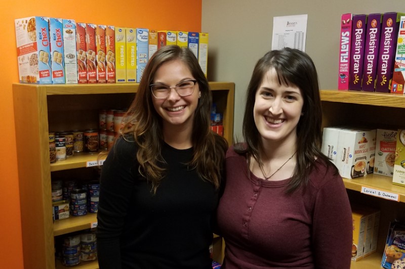 Madison Keller and Anna Winnet pose inside of the Benny's Pantry on the ISU Meridian campus