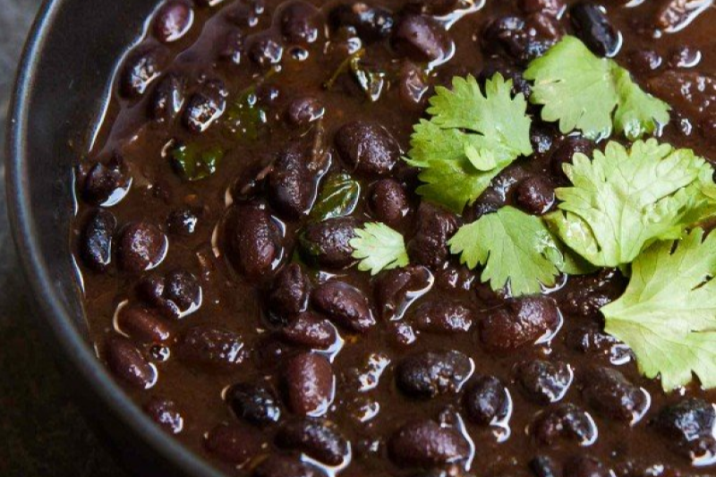 Cooked black beans in a blue bowl