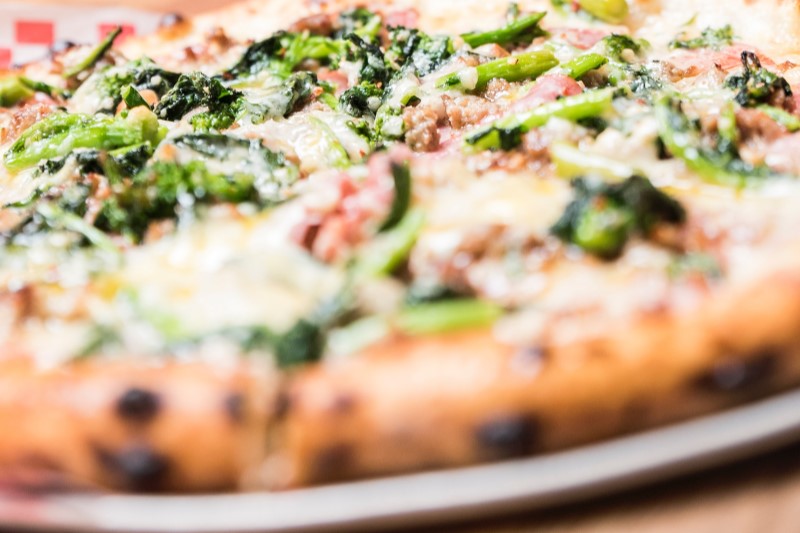 Vegetable pizza on round aluminum pan