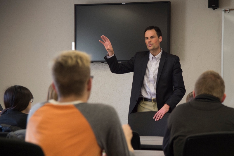 A professor teaching in front of class.