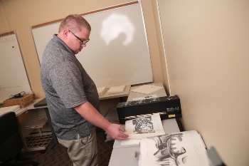 Eric Hall printing braille.