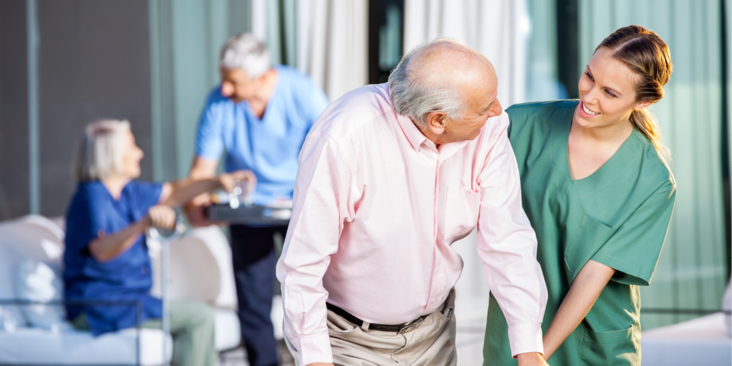 Caretaker assists elderly patient