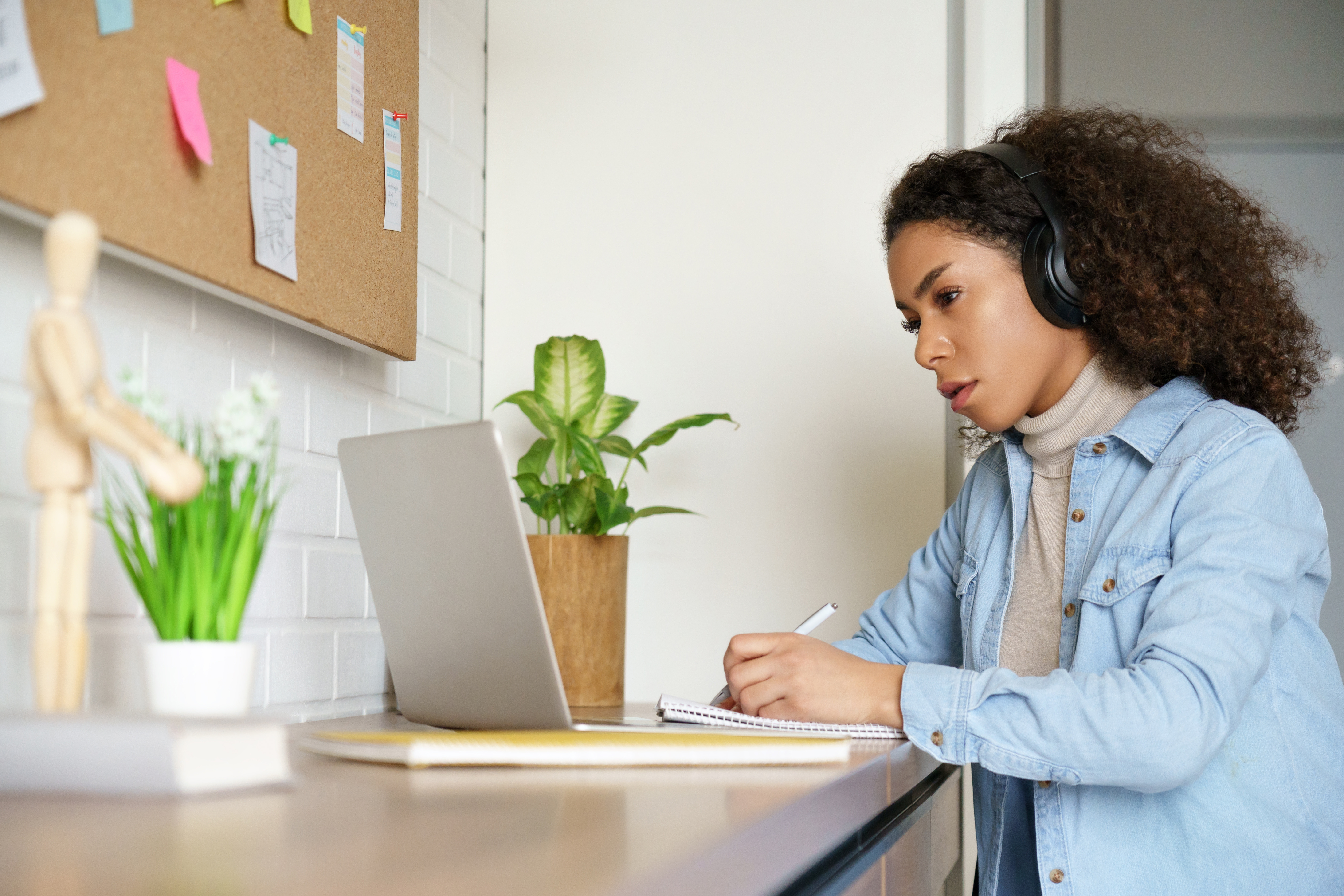 African American woman using a computer to receive telehealth counseling services