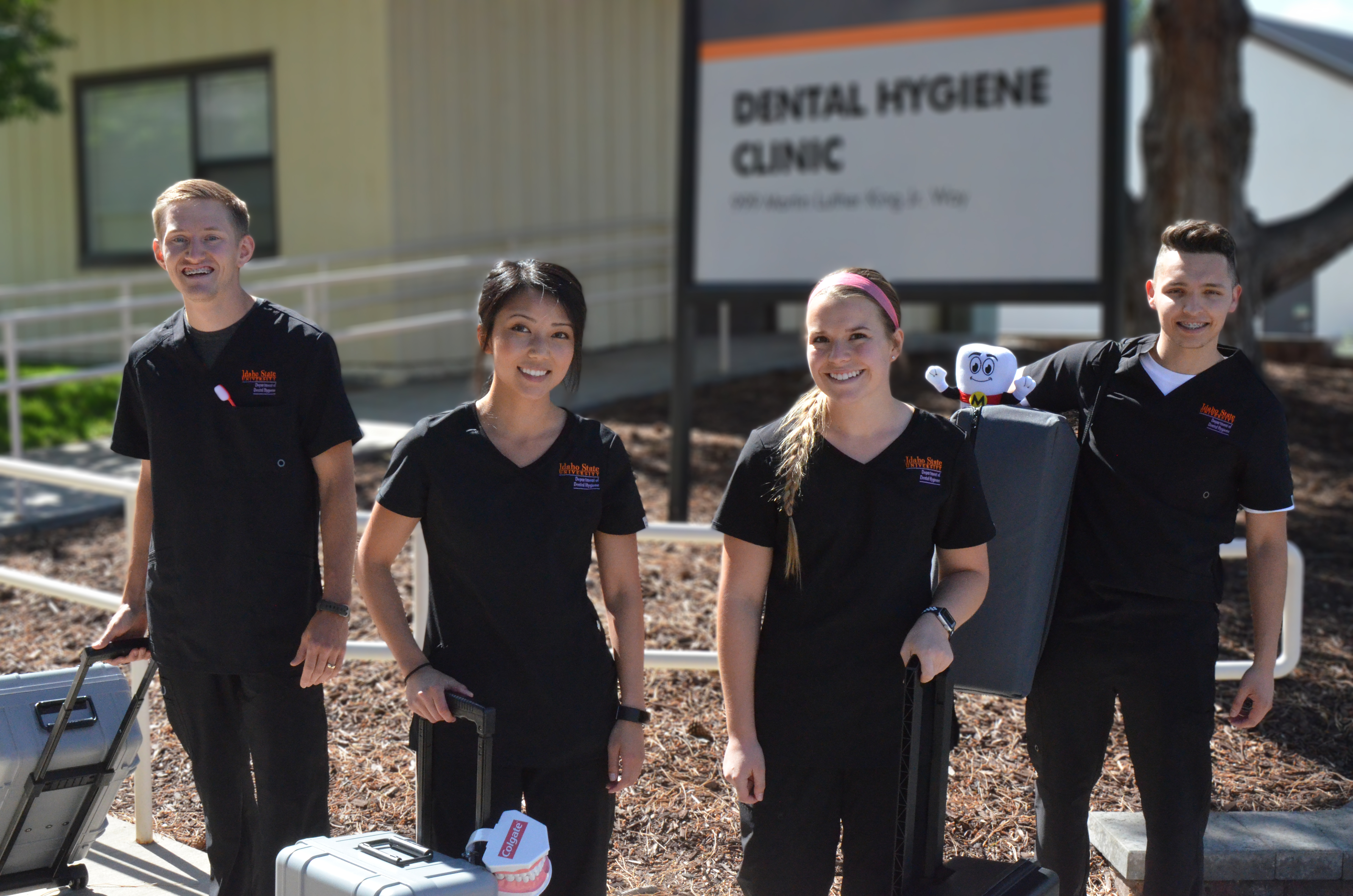 Students in Idaho State University's dental hygiene program carry equipment in portable cases in preparation for Bengal Smiles for Life, a teledentistry program.
