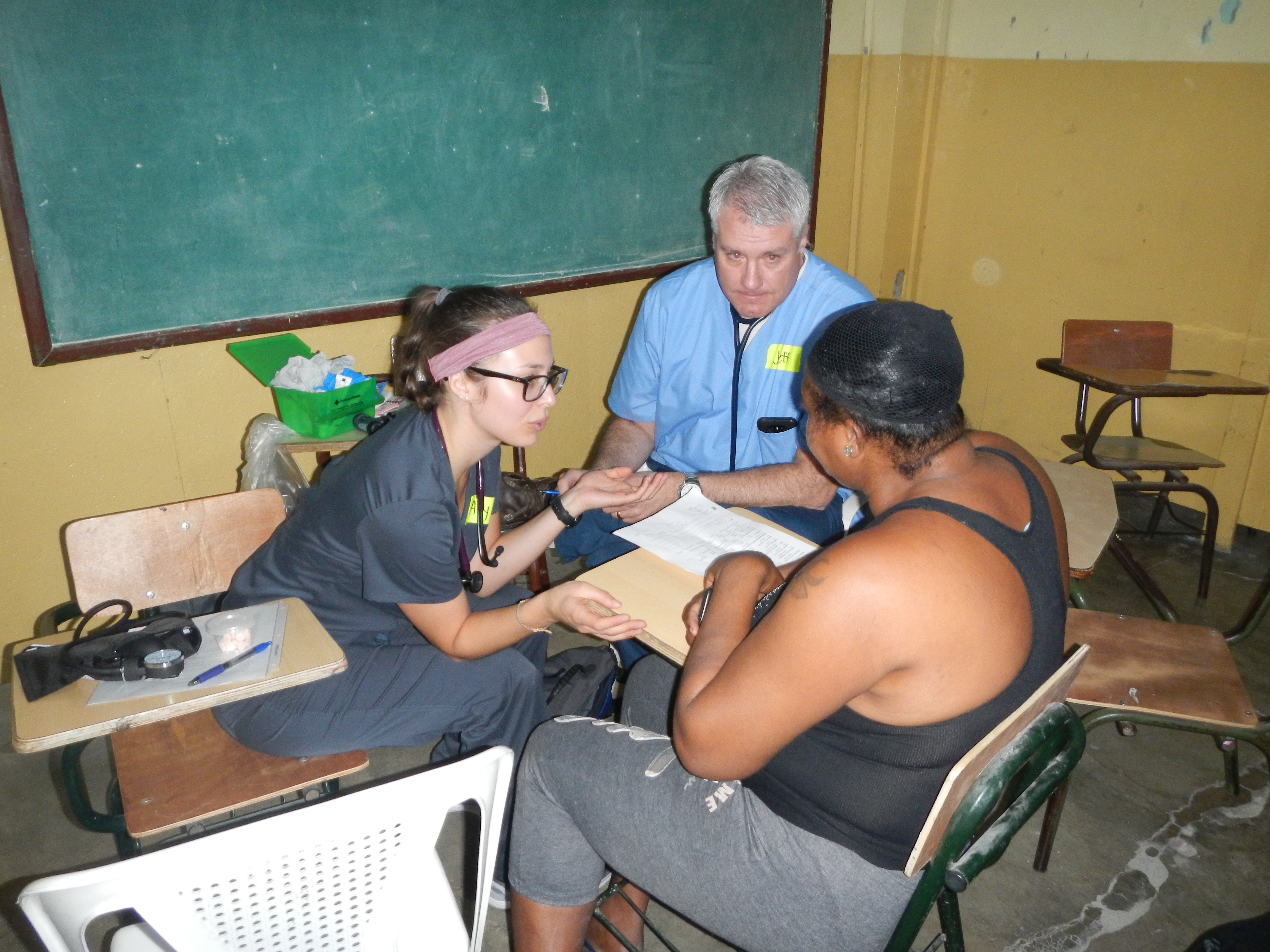 Faculty and students talk with a patient in the Dominican Republic
