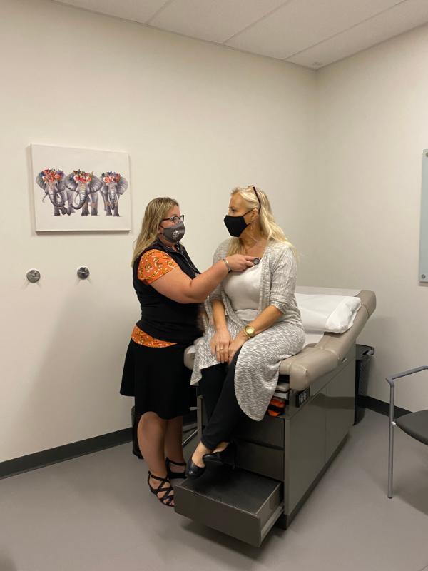 Michelle Anderson performs diagnostics on the first patient at the ISU Meridian Health Care Clinic