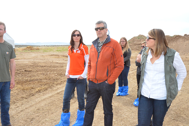 ISU's Natalie Christensen, Rex Force, Collette Wicom-Call, Joe Borich, and Benny the Bengal tour Eagle Ridge Dairy with representatives from Dairy West, as part of their partnership in sponsoring the SCORE program.