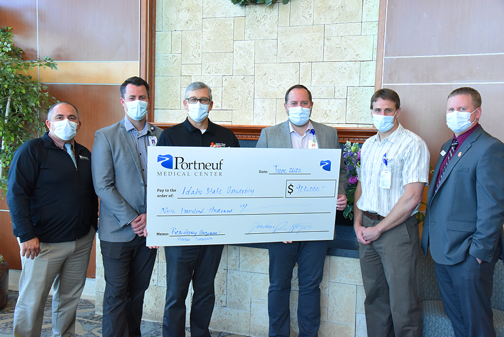 ISU officials pose with Portneuf Medical Center officials to receive donation check