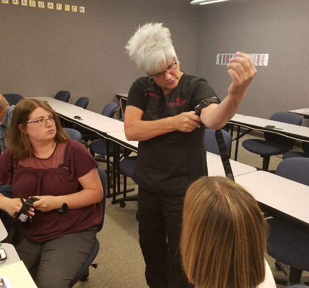 Saint Alphonsus trauma nurses Cheryl Bice and Marie Krochmal train faculty and staff members at ISU-Meridian on how to administer aid in bleeding emergencies.