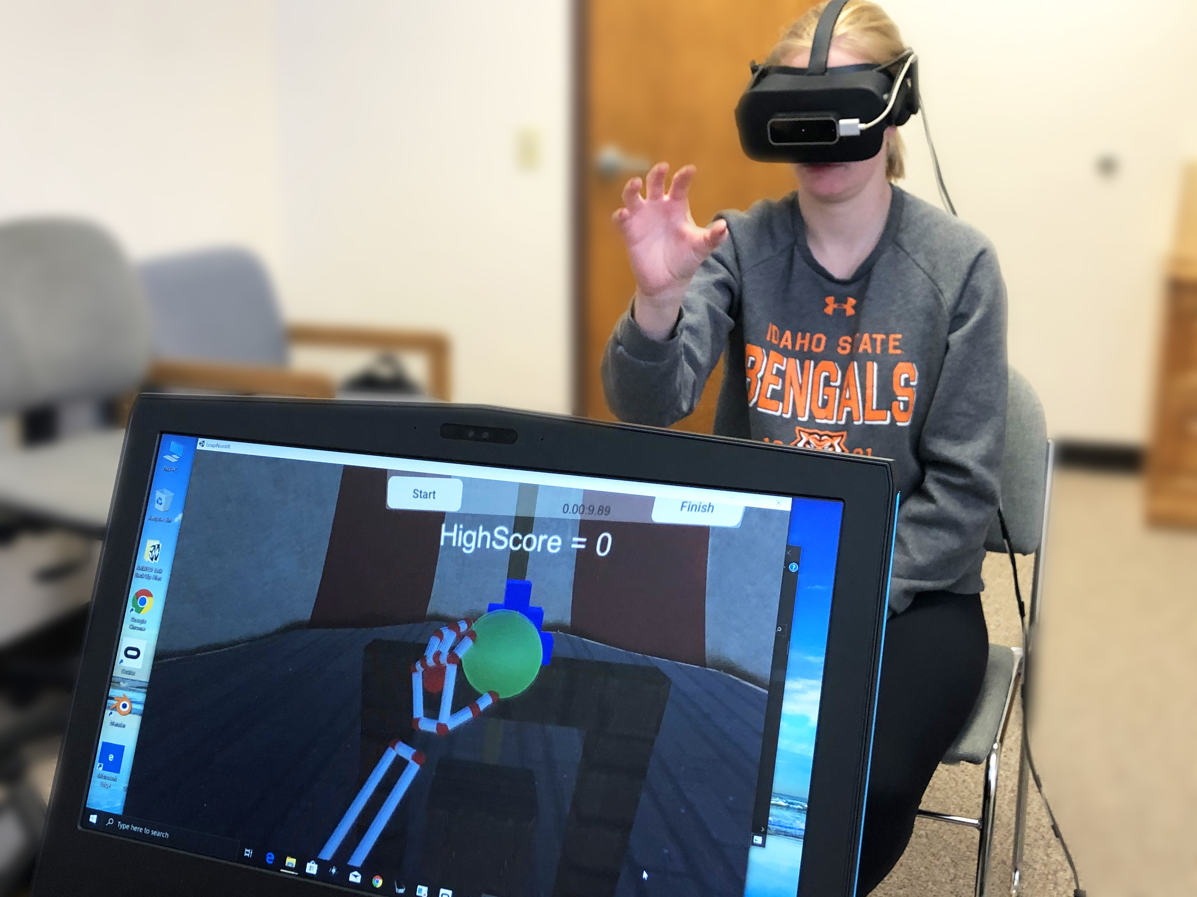 ISU student test the virtual reality headset and equipment used to help victims of stroke