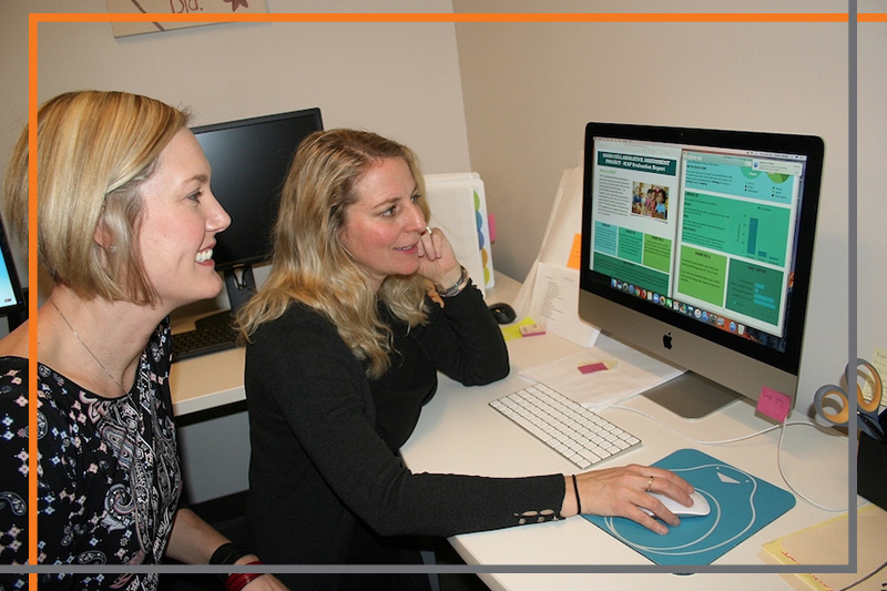 Gabe Bargen and Kristina Blaiser work together at a computer on a new, interactive and easy to read visualization of results to be shown to parents with children who are deaf or hard of hearing.