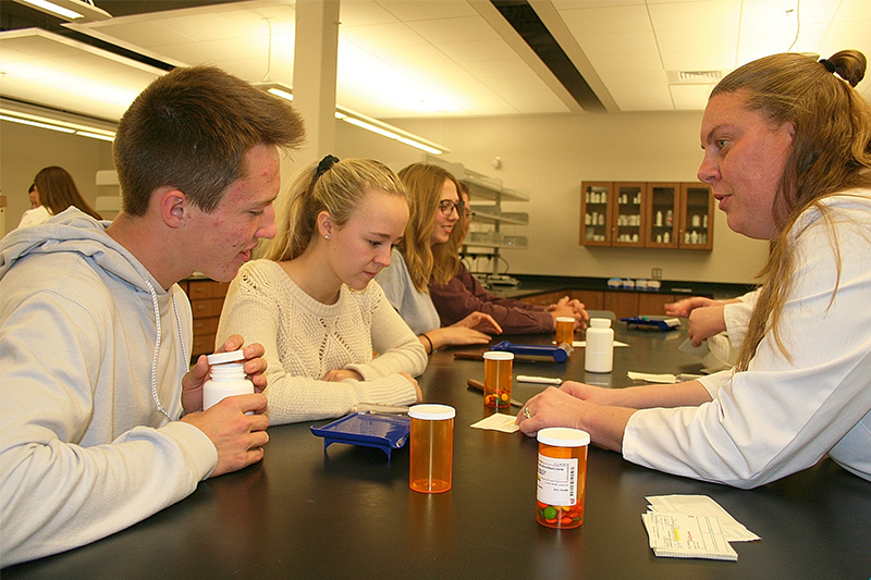 High school students attending Health Science Experience Night at ISU-Meridian learn about prescription medications and compounding from faculty in the College of Pharmacy.