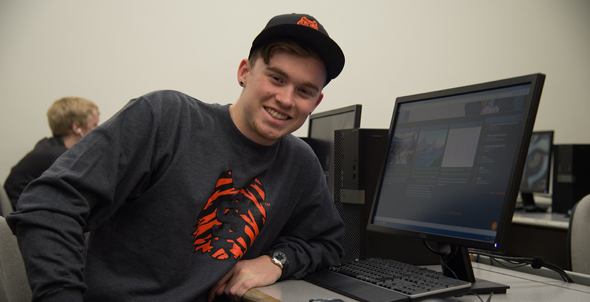 I S U Student sitting at a computer