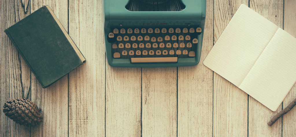 A typewriter and papers displayed on a table