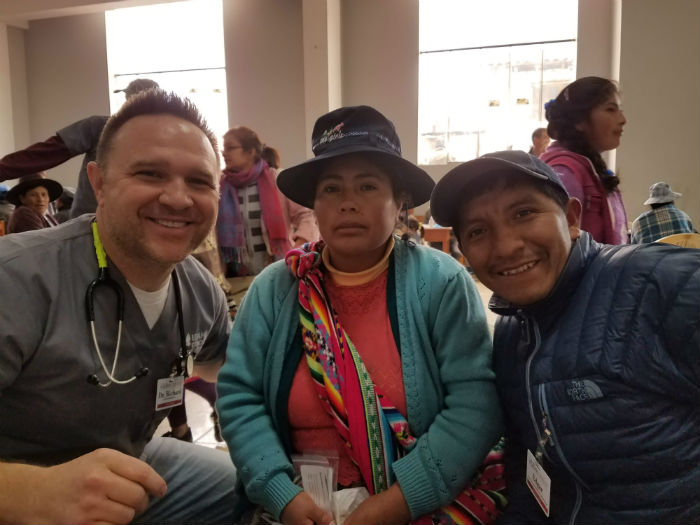 Physician with two patients in Peru Clinic