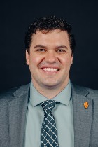 Professional headshot of Dr. Anderson with suit and tie.