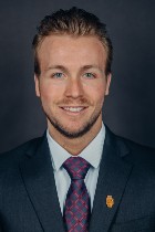 Professional headshot of Jordan Hammon with suit and tie.