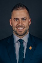 Professional headshot of Nicholas Henrie with suit and tie