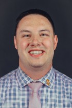 Professional headshot of Trevor Miller with suit and tie