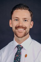 Professional headshot of Cody Patterson with tie
