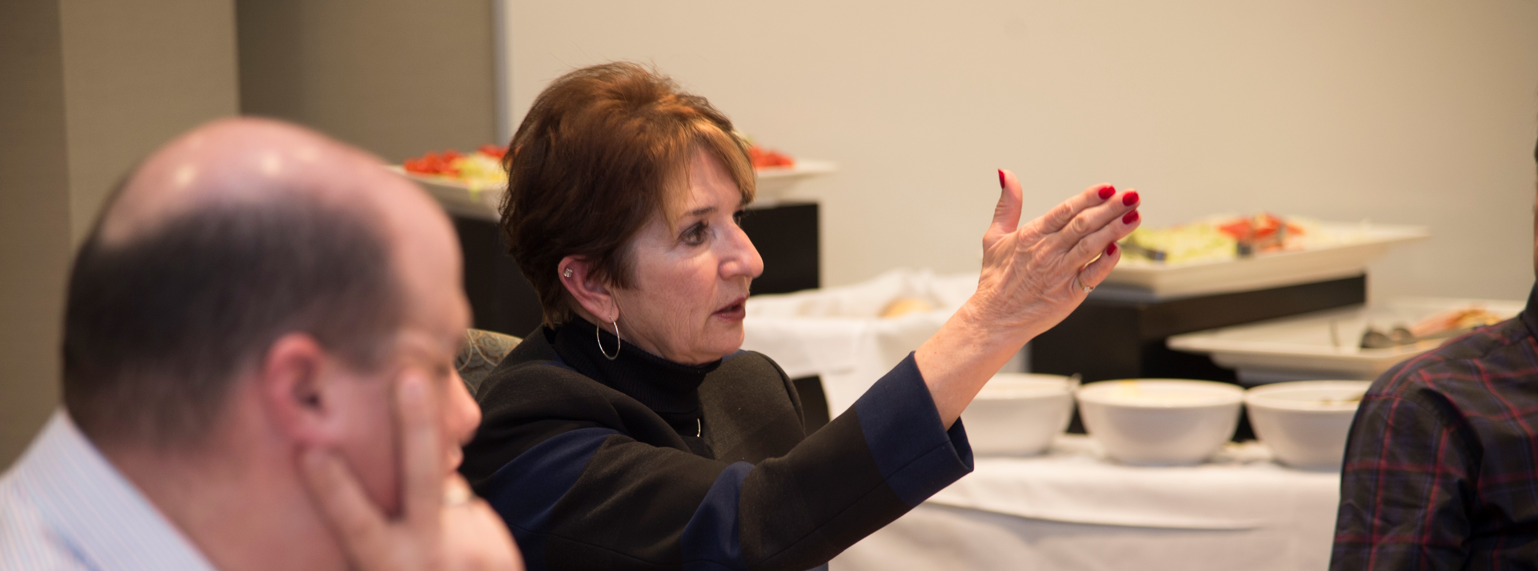 A woman gesturing to something during a meeting