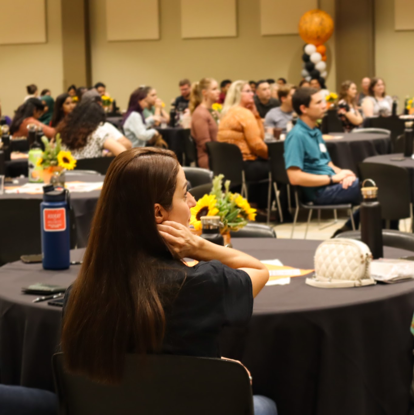 close up of a student listening to the GNSO speaker on stage