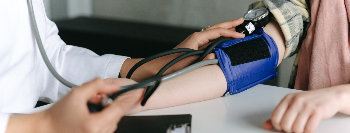 Individual having blood pressure measured by a health professional
