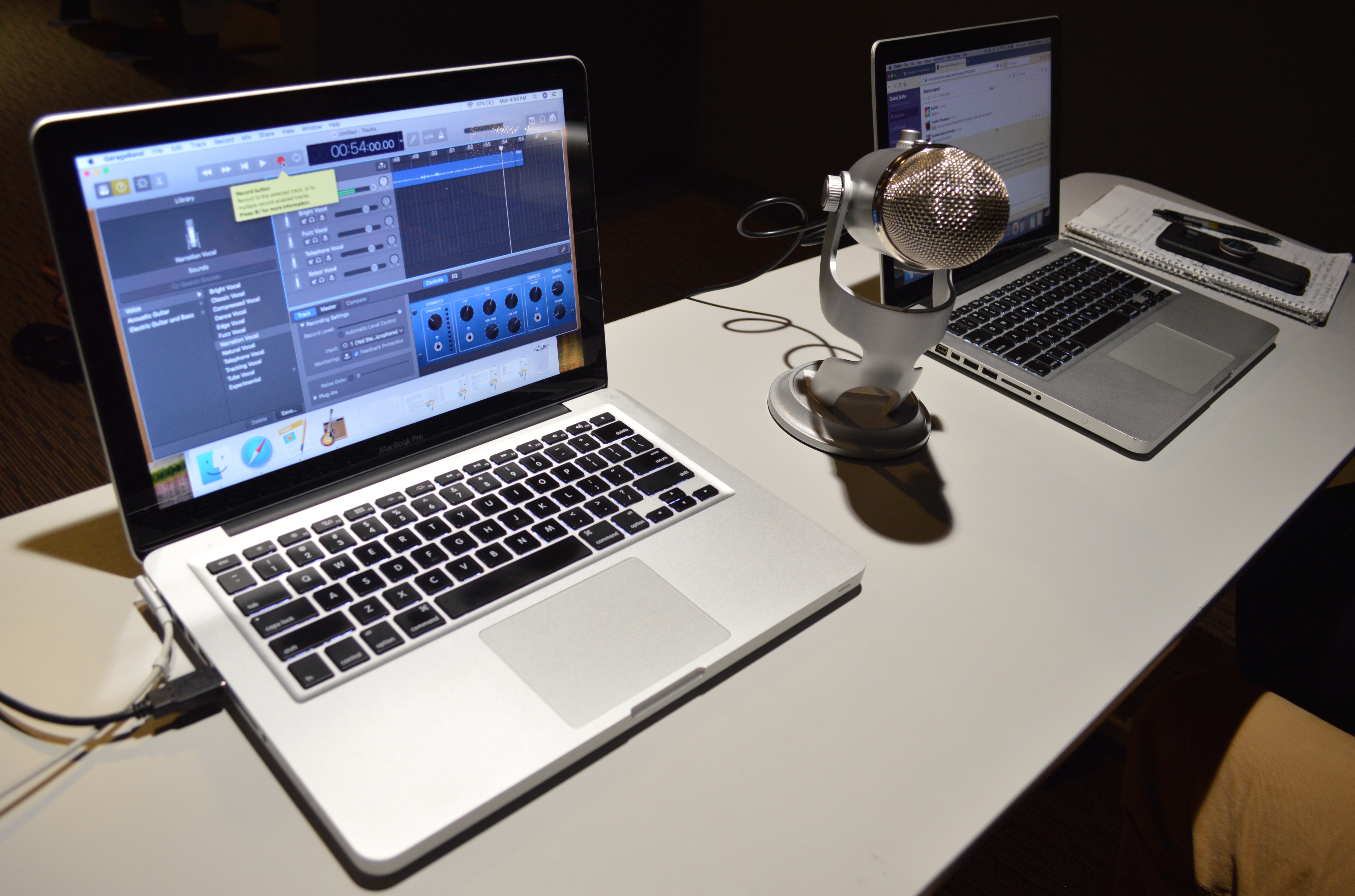 podcast recording equipment, including microphone and laptops