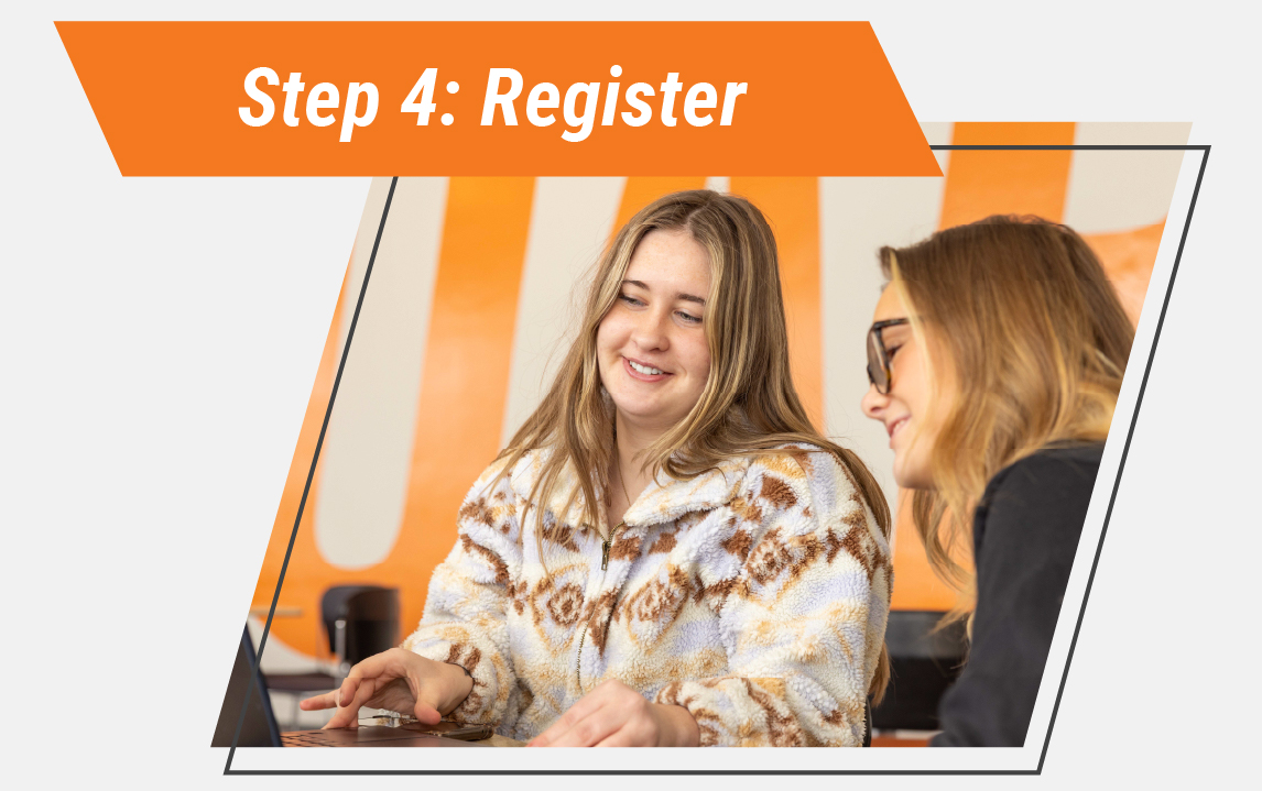 Two students sit together at a table, smiling as one uses a laptop while the other looks on for support. Text at the top reads ‘Step 4: Register,’ indicating the final step in the enrollment process.