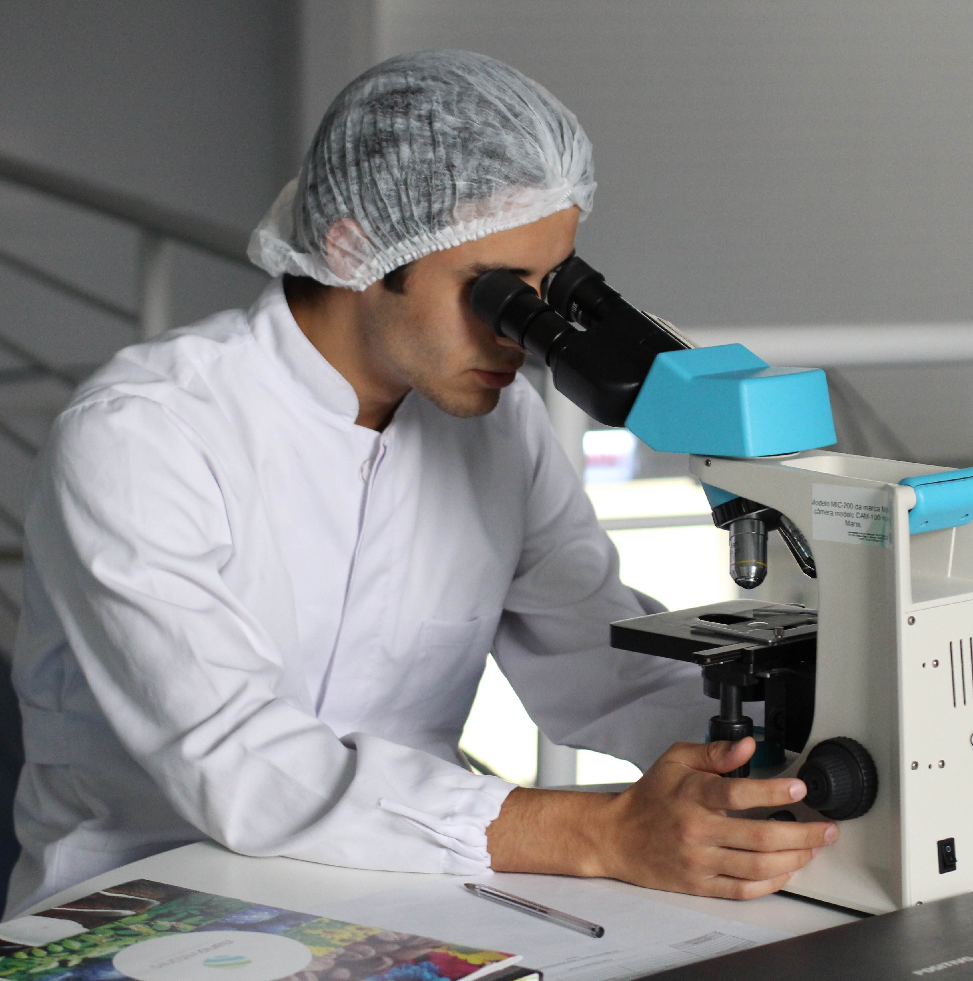 a researcher at a microscope
