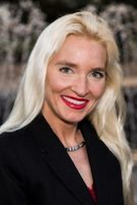 A medium skin toned woman with white hair wearing a black shirt