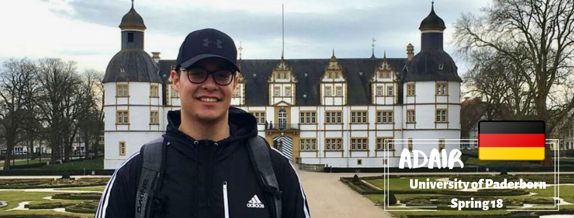 A student in front of a building. 