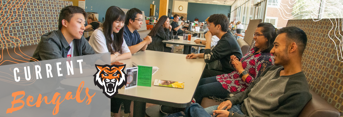 Students around a table. 