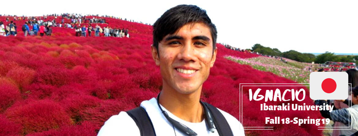 A man next to some flowers. 