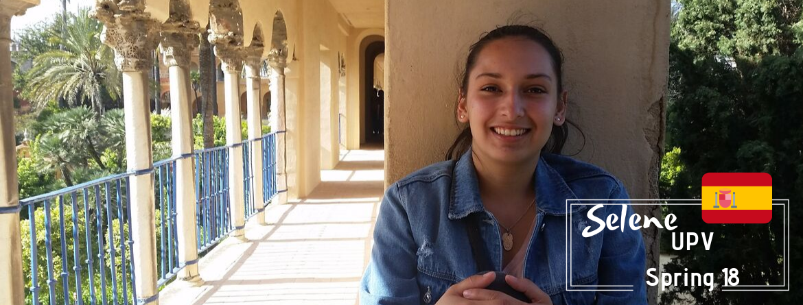 A student sitting in a hall way. 