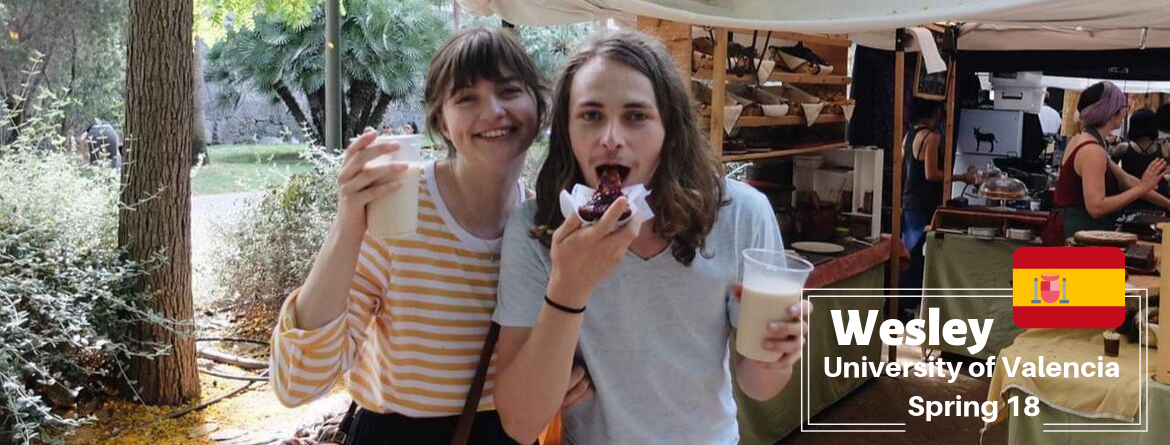 A man eating a cake with a friend. 