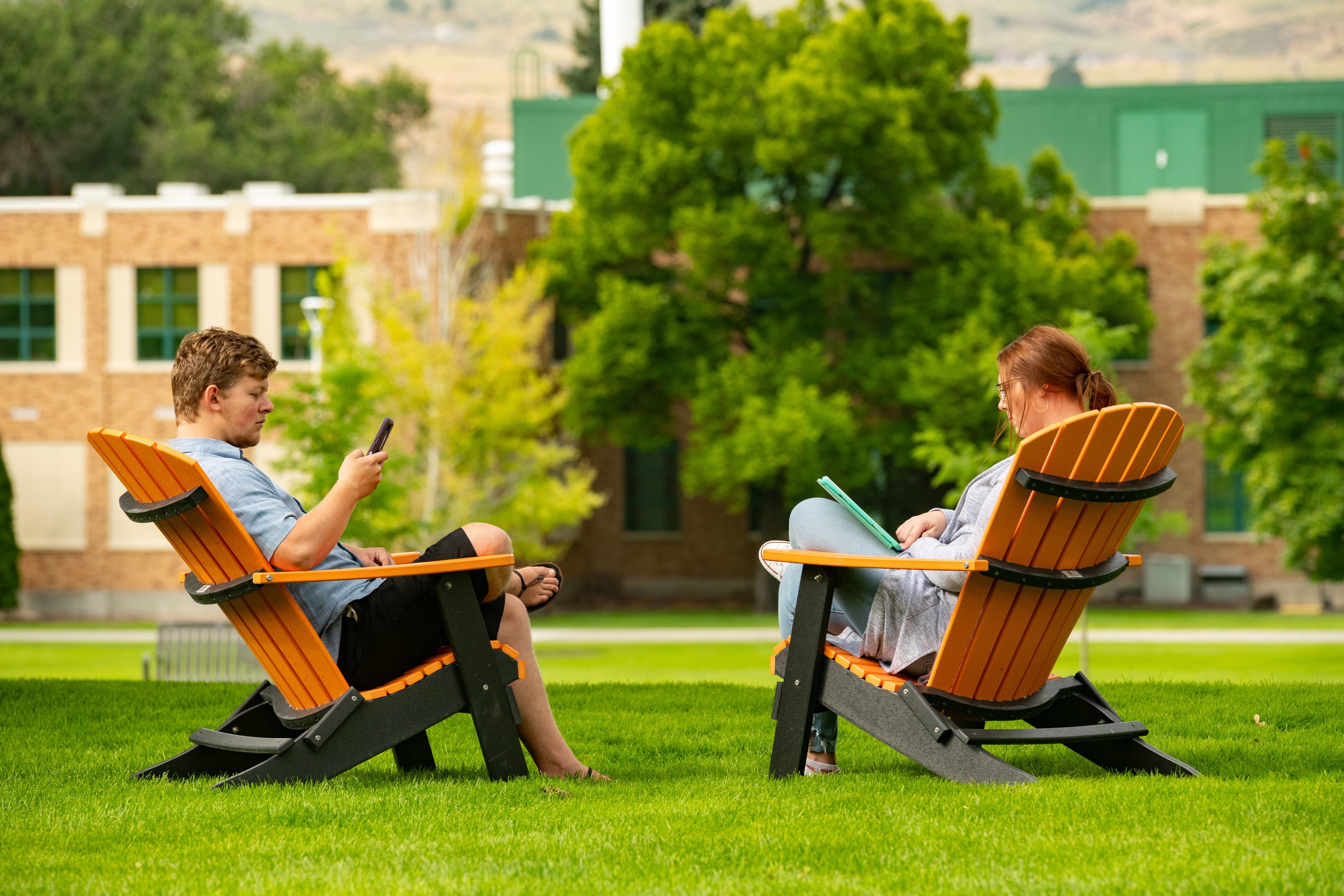 Students talking in lawn chairs on the quad.
